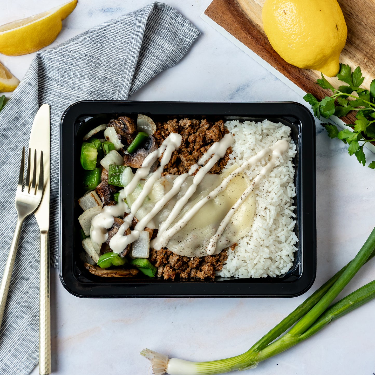 Smothered Philly Bowl - Ground beef smothered with sautéed peppers, onions, mushrooms, and provolone, served over basmati rice