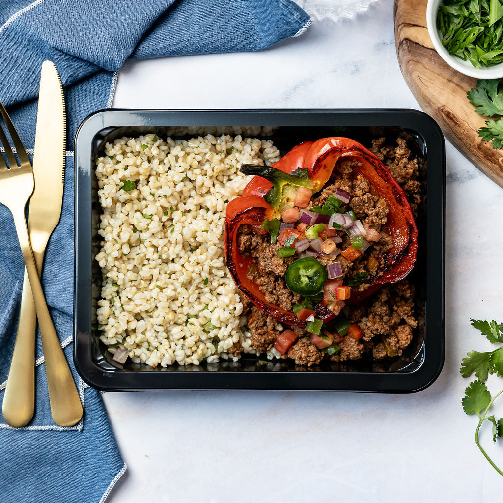 Taco Stuffed Pepper - Roasted sweet red bell pepper filled with seasoned beef and salsa, served with cilantro-lime rice and fresh pico