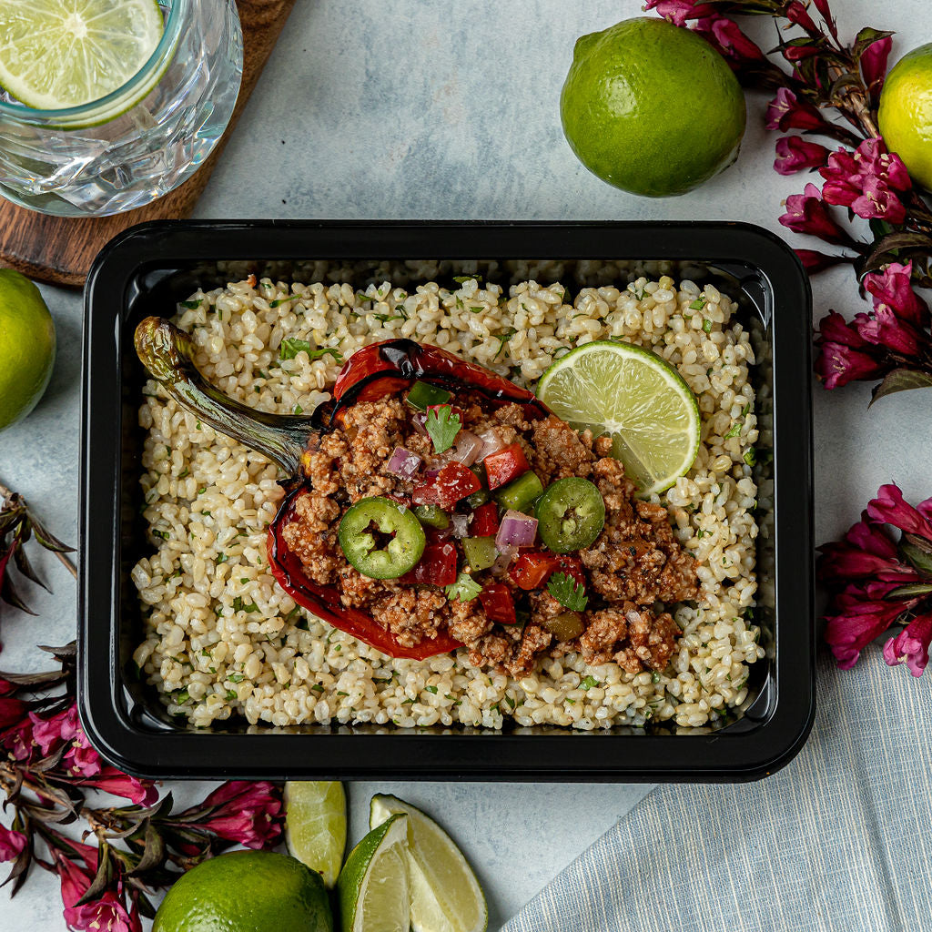 Turkey Taco Stuffed Pepper - Bell pepper stuffed with salsa-seasoned ground turkey and topped with pico