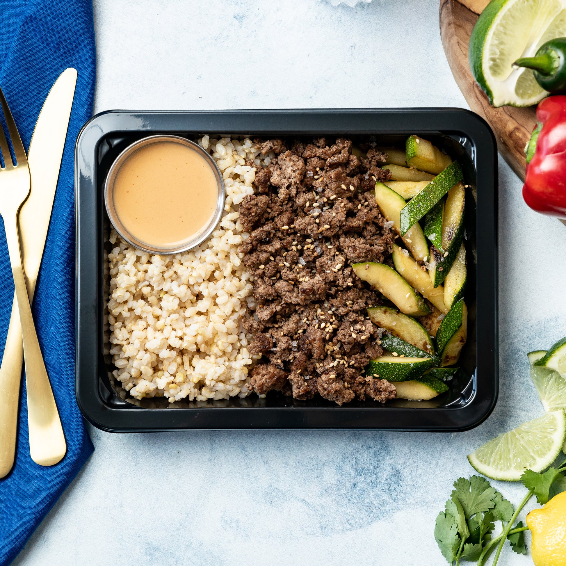 Asian Beef & Rice - Savory ground beef tossed with Asian-inspired seasoning, paired with rice, zucchini, and topped with sesame seeds