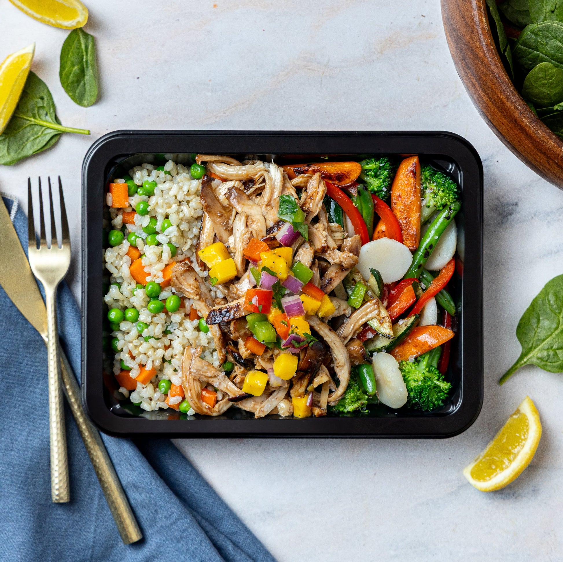 Honey Sriracha Chicken - Soy-marinated seared chicken thigh topped with mango salsa and sesame seeds, served with sesame brown rice pilaf and stir fry veggies