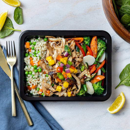 Honey Sriracha Chicken - Soy-marinated seared chicken thigh topped with mango salsa and sesame seeds, served with sesame brown rice pilaf and stir fry veggies