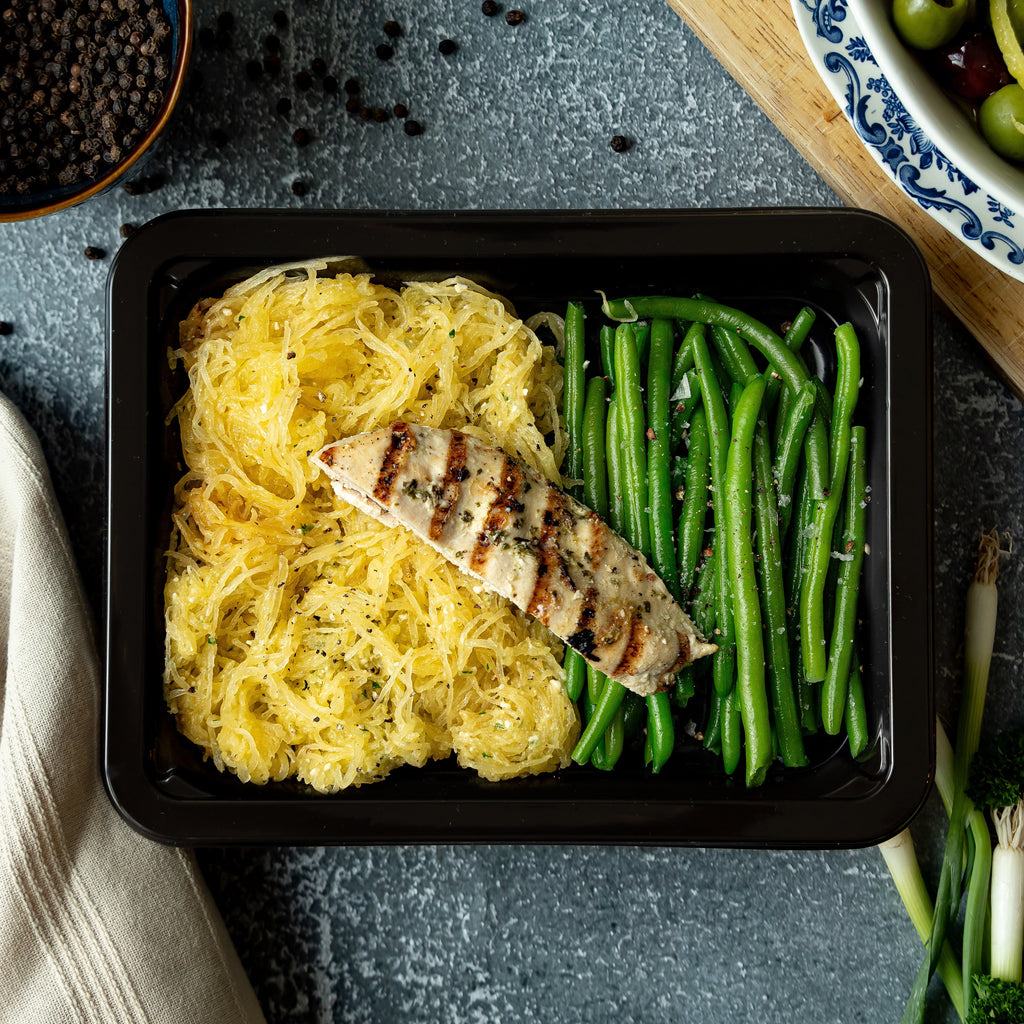 Herb Chicken & Truffle Spaghetti Squash - Half of an herb-roasted chicken breast over golden spaghetti squash tossed in truffle oil, fresh basil, garlic, and pine nuts, with tender…