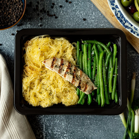 Herb Chicken & Truffle Spaghetti Squash - Half of an herb-roasted chicken breast over golden spaghetti squash tossed in truffle oil, fresh basil, garlic, and pine nuts, with tender…