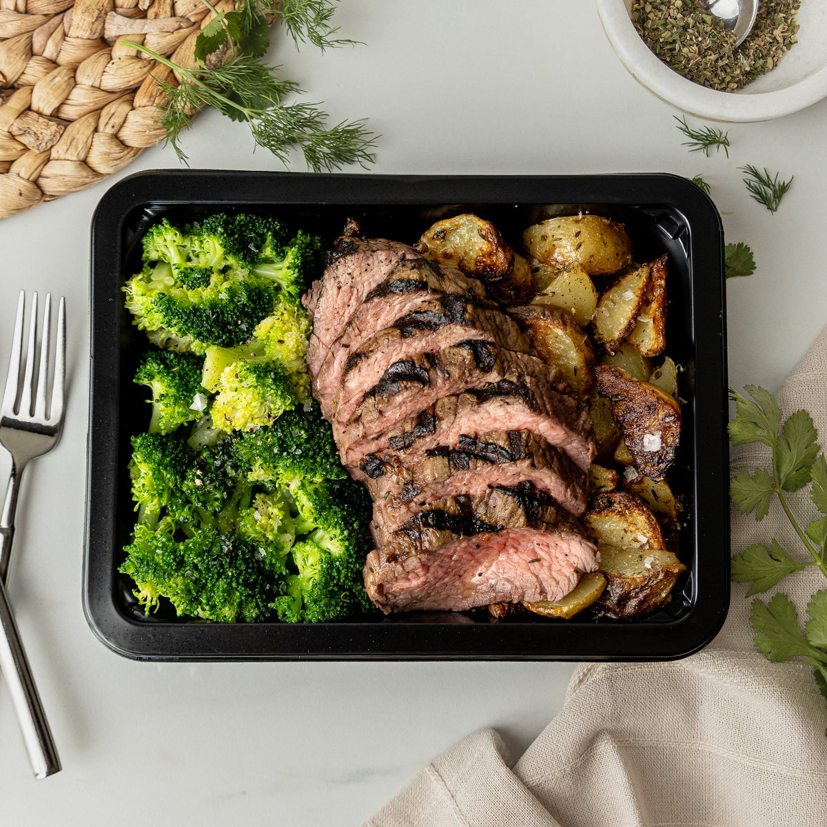 Steak & Garlic Parm Potatoes - Juicy grilled steak paired with golden Yukon potatoes roasted with garlic and parmesan, finished with fresh herbs and a hit of lemon