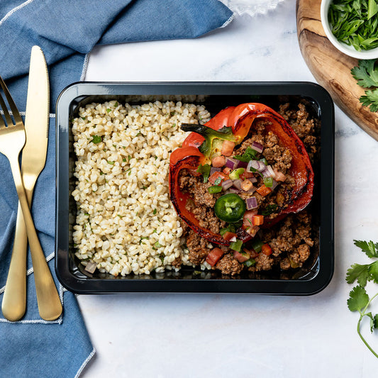 Taco Stuffed Pepper - Roasted sweet red bell pepper filled with seasoned beef and salsa, served with cilantro-lime rice and fresh pico