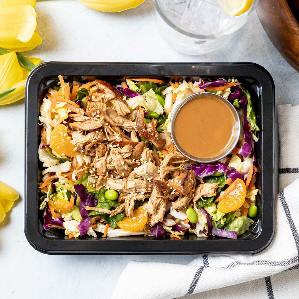 Chinese Chicken Salad - Shredded napa cabbage, crisp romaine, and carrots with honey-soy marinated shredded chicken thigh, mandarin oranges, edamame, and cashews